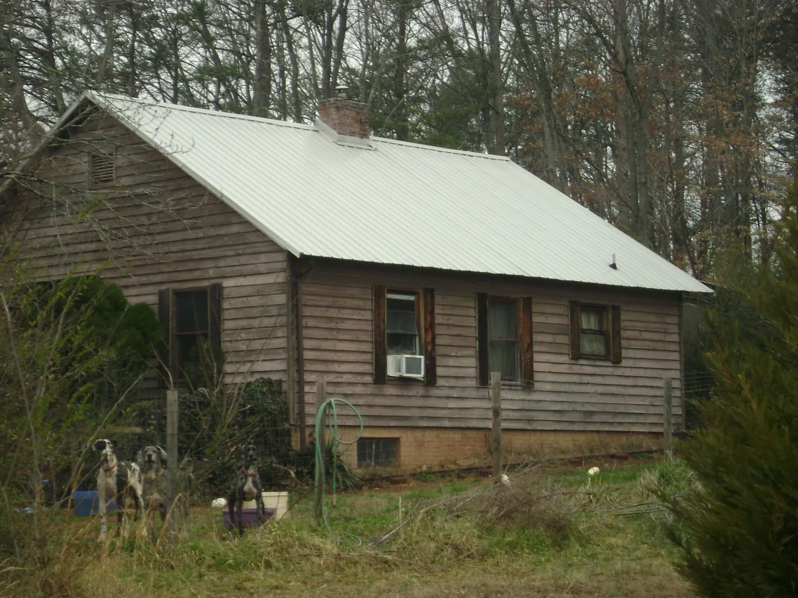 White metal roof on an old wood sided farmhouse, from a Metal Roof Installation job in Koppel